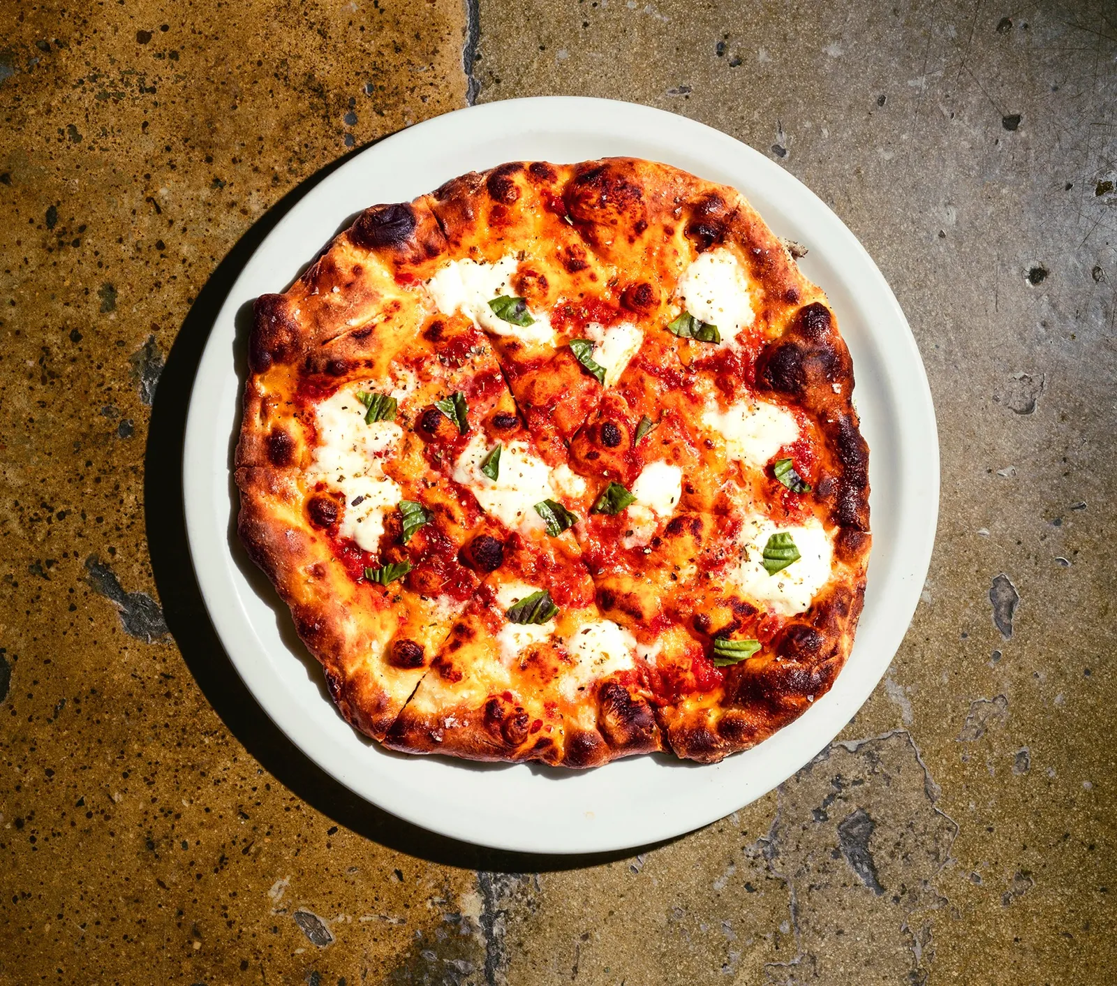 Pizzeria Toro signature dishes Margherita Pizza, Spicy Lamb Meatball Pizza, Soft Egg and Guanciale Pizza, Kale Salad